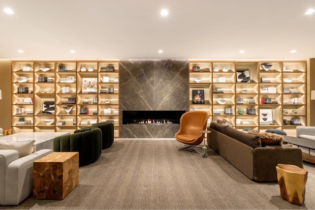 living area with recessed lighting, carpet flooring, and a high end fireplace