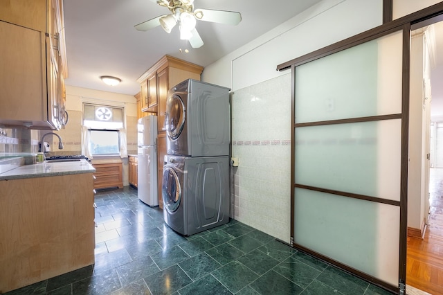3725 Henry Hudson Pkwy W Unit 6-D, New York City, NY 10463 - laundry room with stacked washer / dryer, a ceiling fan, and tile walls