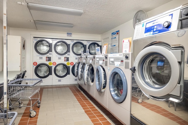 communal laundry room featuring independent washer and dryer, a textured ceiling, stacked washer / dryer, and tile patterned flooring
