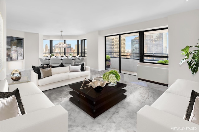 living room with a view of city, baseboards, and an inviting chandelier