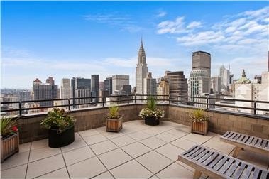 view of patio / terrace featuring a view of city and a balcony