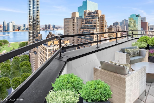 balcony with a water view and a city view