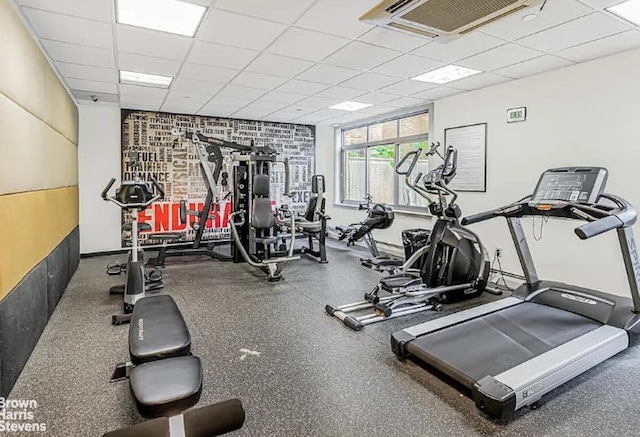 gym featuring a paneled ceiling and visible vents