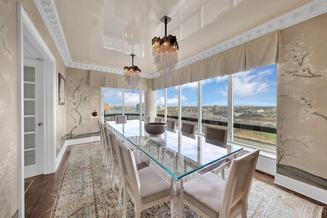 sunroom / solarium featuring a raised ceiling