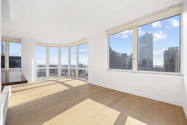 unfurnished sunroom with a city view