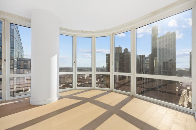 unfurnished sunroom with a city view