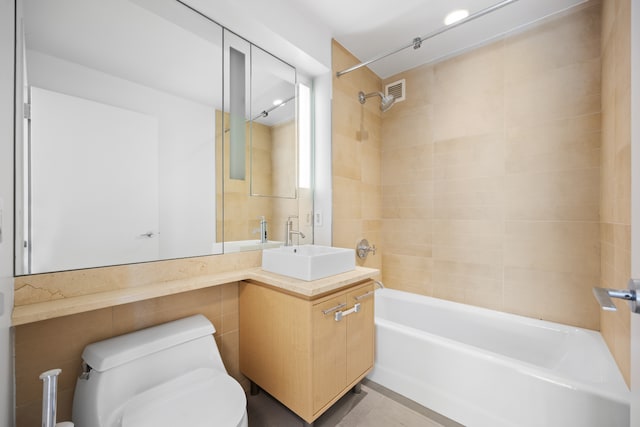 bathroom with visible vents, vanity, toilet, and shower / tub combination