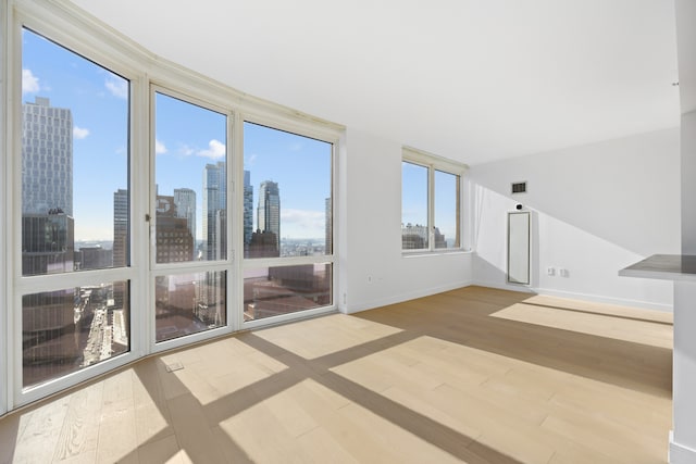 unfurnished sunroom featuring a city view and visible vents