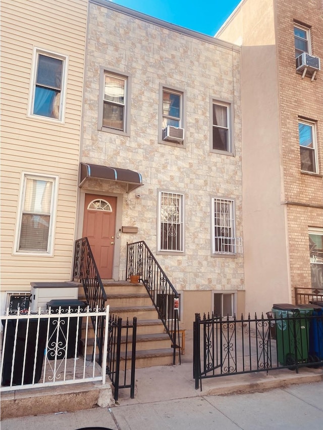 view of property featuring a fenced front yard and cooling unit