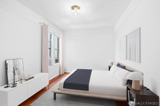 bedroom with dark wood-type flooring