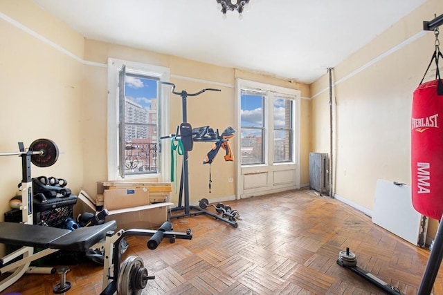 workout area featuring parquet flooring