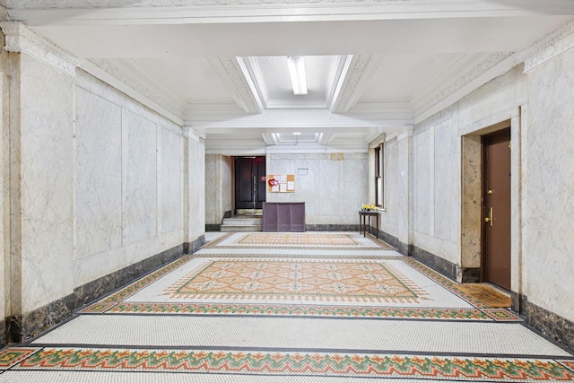 hall featuring coffered ceiling, beamed ceiling, baseboards, and ornamental molding