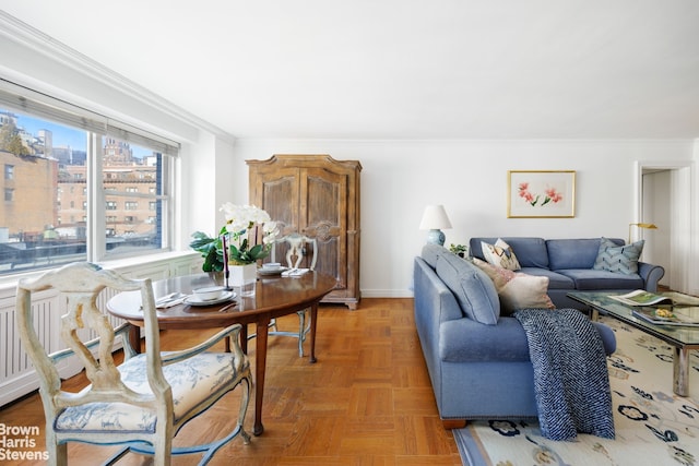 living room featuring crown molding and parquet floors