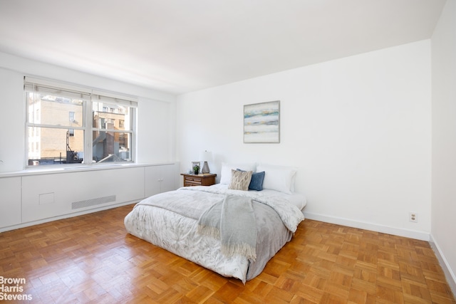 bedroom featuring parquet flooring