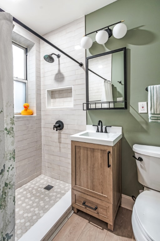 bathroom with vanity, toilet, a shower with shower curtain, and wood-type flooring