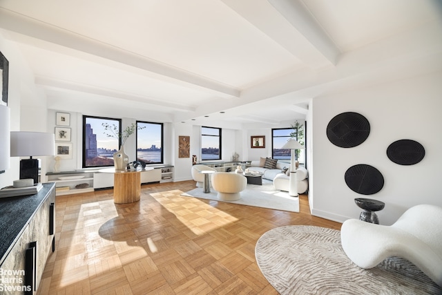 interior space with plenty of natural light, baseboards, and beam ceiling