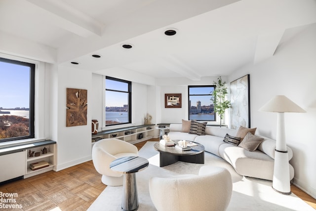 living room with beamed ceiling, light parquet flooring, and a water view