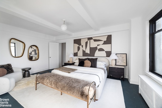 bedroom featuring beam ceiling, radiator heating unit, and baseboards