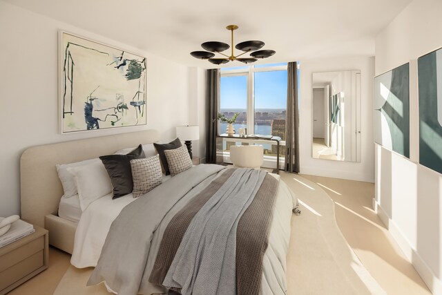 200 Amsterdam Ave Unit 42, New York City, NY 10024 - bedroom featuring a city view, wood finished floors, baseboards, and an inviting chandelier