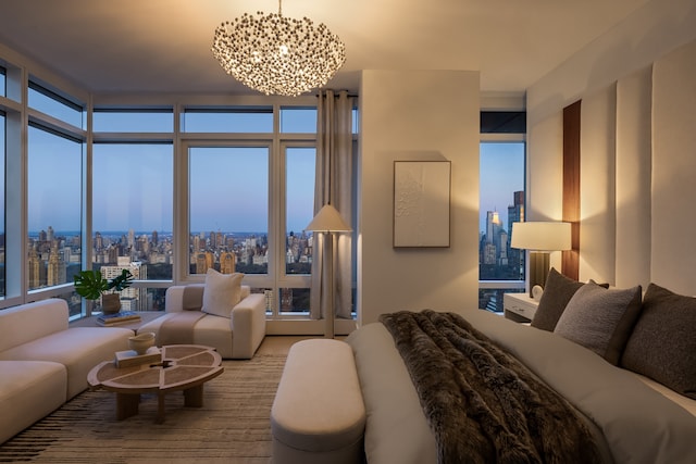 bedroom with a notable chandelier and a view of city