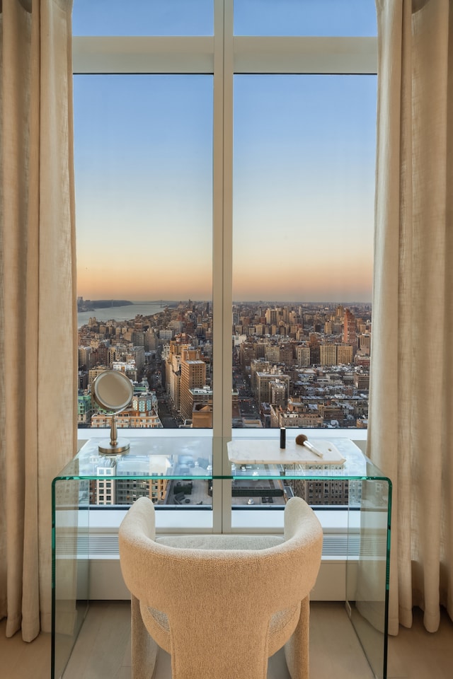 full bathroom with floor to ceiling windows, a freestanding tub, vanity, and a water view