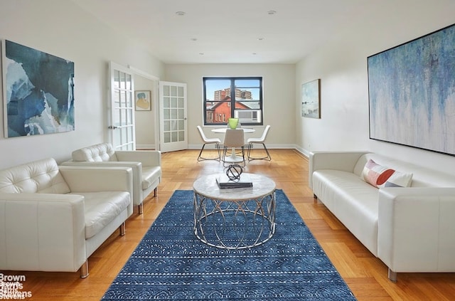 living room featuring cooling unit and light parquet flooring