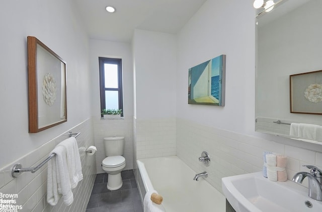 bathroom featuring toilet, sink, tile walls, a bathtub, and tile patterned flooring