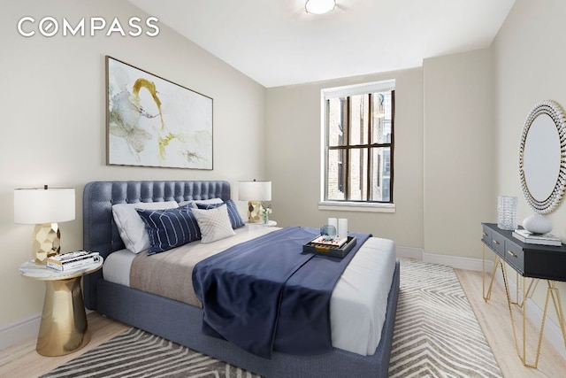 bedroom featuring vaulted ceiling and wood-type flooring