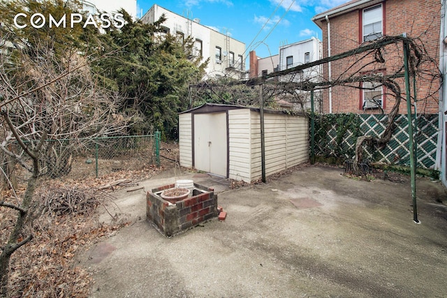 exterior space with a shed and fence