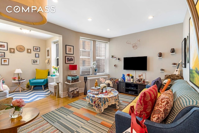 living area featuring recessed lighting, cooling unit, baseboards, and wood finished floors