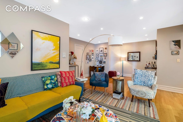 living room with baseboards, wood finished floors, and recessed lighting