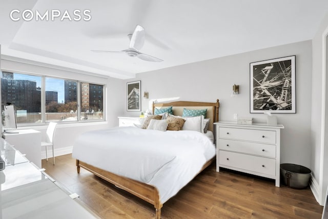 bedroom featuring dark wood-style floors, baseboards, and ceiling fan