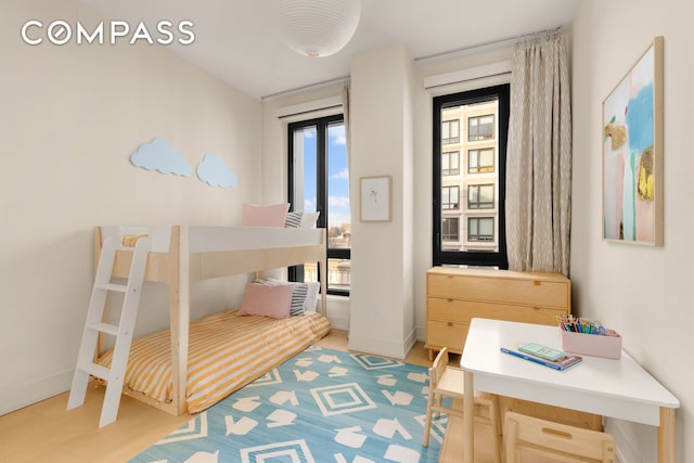 bedroom featuring light wood-style flooring and baseboards