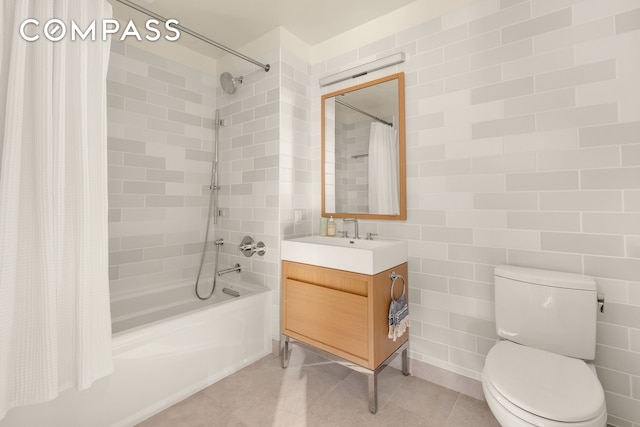 full bath featuring toilet, shower / bath combo, vanity, and tile patterned flooring