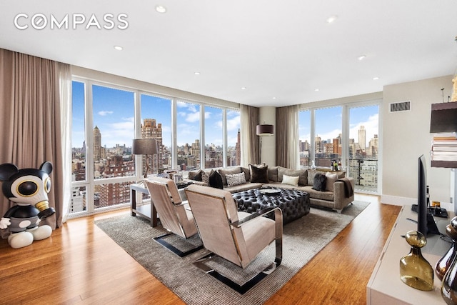 living room featuring floor to ceiling windows and light hardwood / wood-style flooring