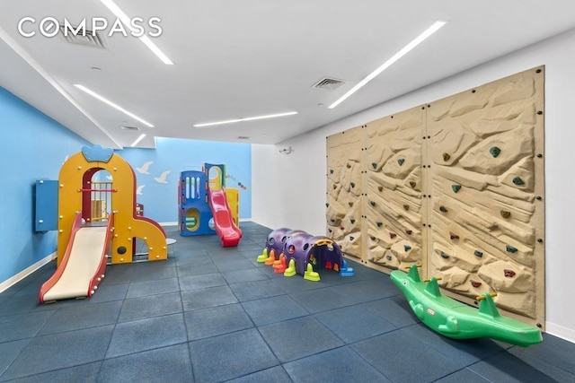 recreation room featuring baseboards and visible vents