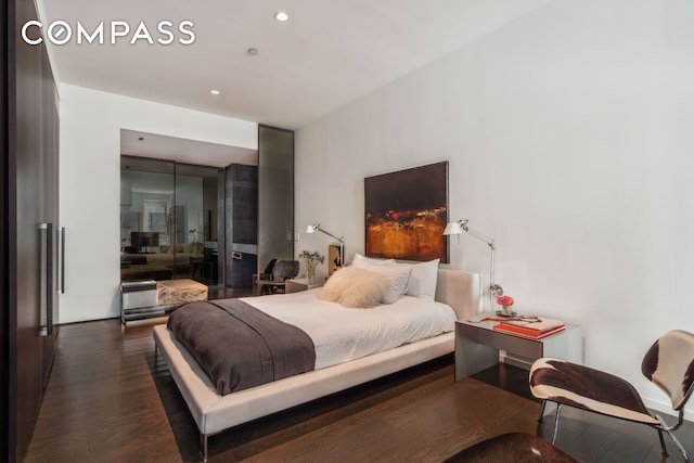 bedroom featuring dark wood-type flooring and recessed lighting