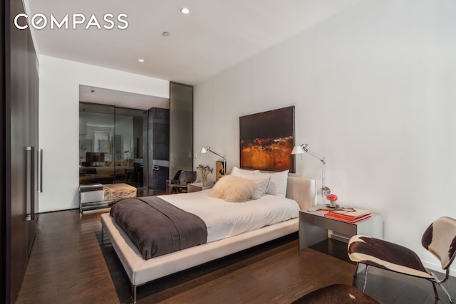 bedroom with recessed lighting and dark wood finished floors