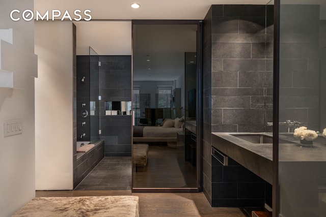 ensuite bathroom with recessed lighting, ensuite bath, a relaxing tiled tub, and wood finished floors