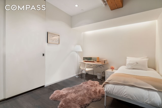 bedroom with baseboards and wood finished floors