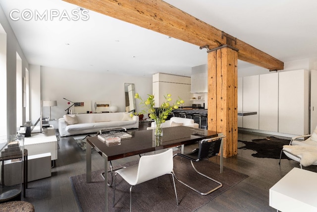 dining space with beamed ceiling and dark wood-type flooring