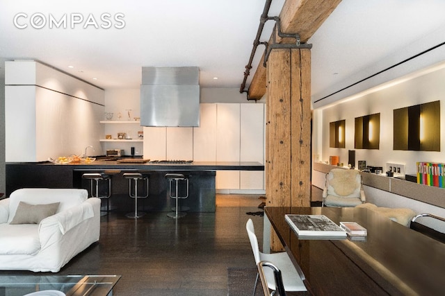 interior space featuring extractor fan, dark wood-type flooring, and white cabinets