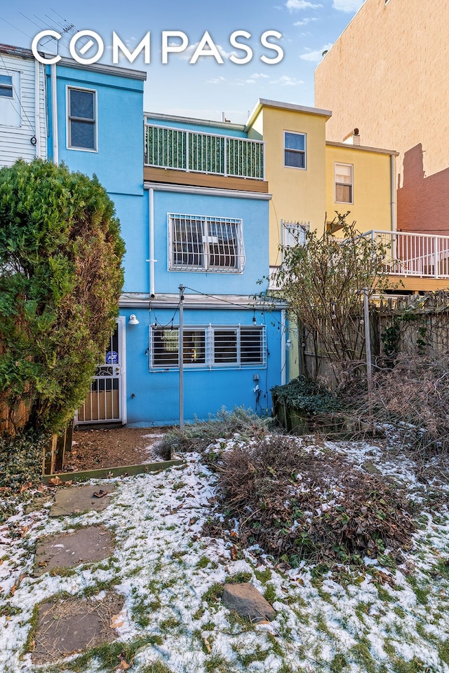 back of property featuring stucco siding and a balcony