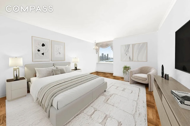 bedroom featuring ornamental molding and an inviting chandelier