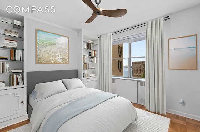 bedroom with ceiling fan, crown molding, radiator heating unit, and baseboards