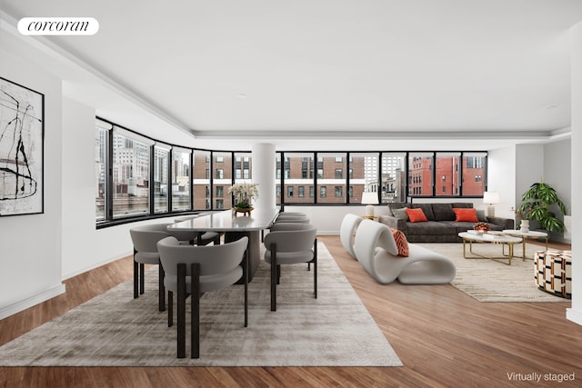 dining area with baseboards, visible vents, and wood finished floors