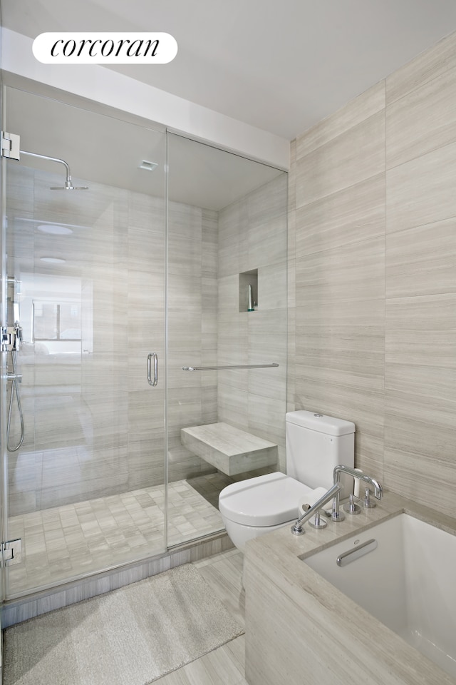 211 Madison Ave Unit 16B, New York City, NY 10016 - full bath with toilet, tile walls, a bath, a stall shower, and a sink
