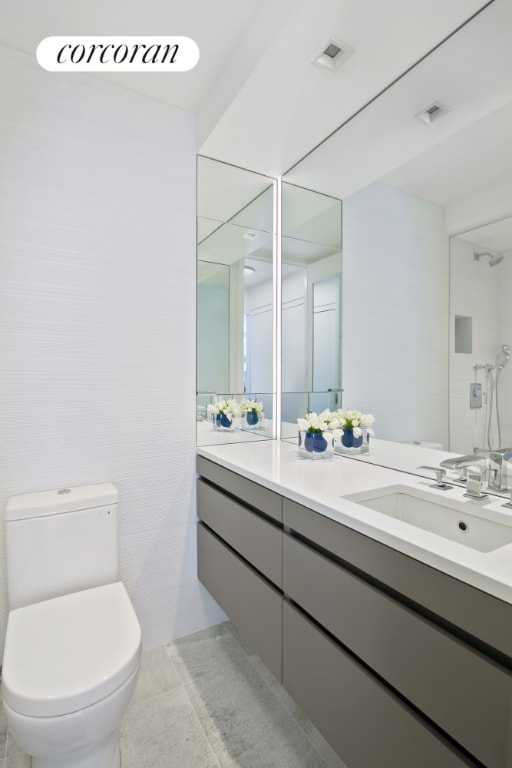 bathroom featuring visible vents, vanity, toilet, and tile patterned floors