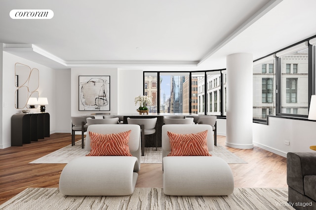 living room featuring wood finished floors, visible vents, and baseboards