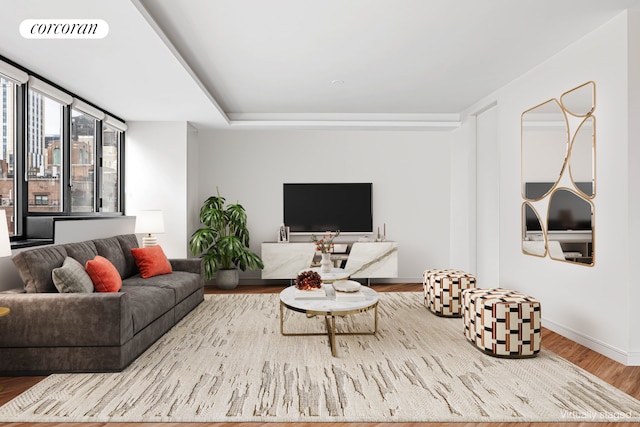 living room featuring wood finished floors, visible vents, and baseboards